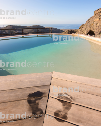 Wet footprints at the edge of the pool